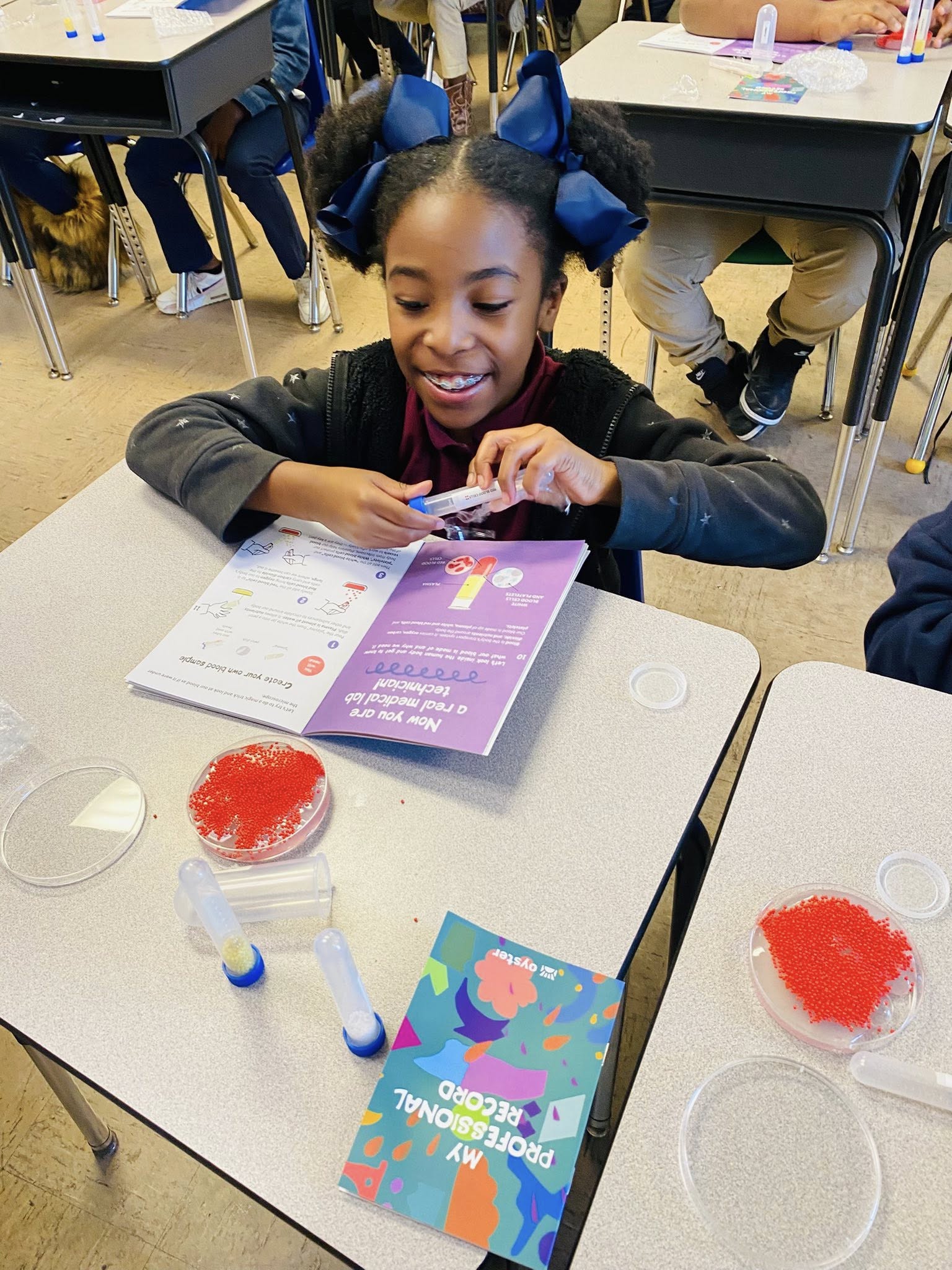 A girl a school desk.